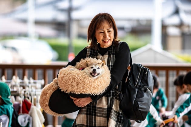 Atsuko Sato with her shiba inu, Kabosu, who became the face of the "doge" meme, in March 2024. - Credit: PHILIP FONG/AFP/Getty Images