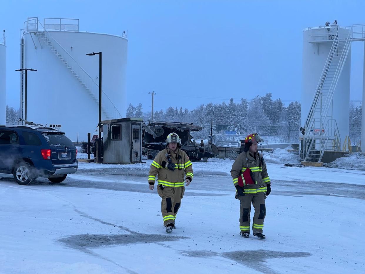 Firefighters responded to a fire Friday morning in Yellowknife near large fuel tanks just north of the airport. (Robert Holden/CBC - image credit)