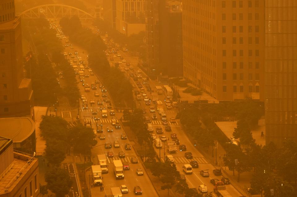 Traffic moves along in New York on Wednesday amidst smokey haze from wildfires in Canada.