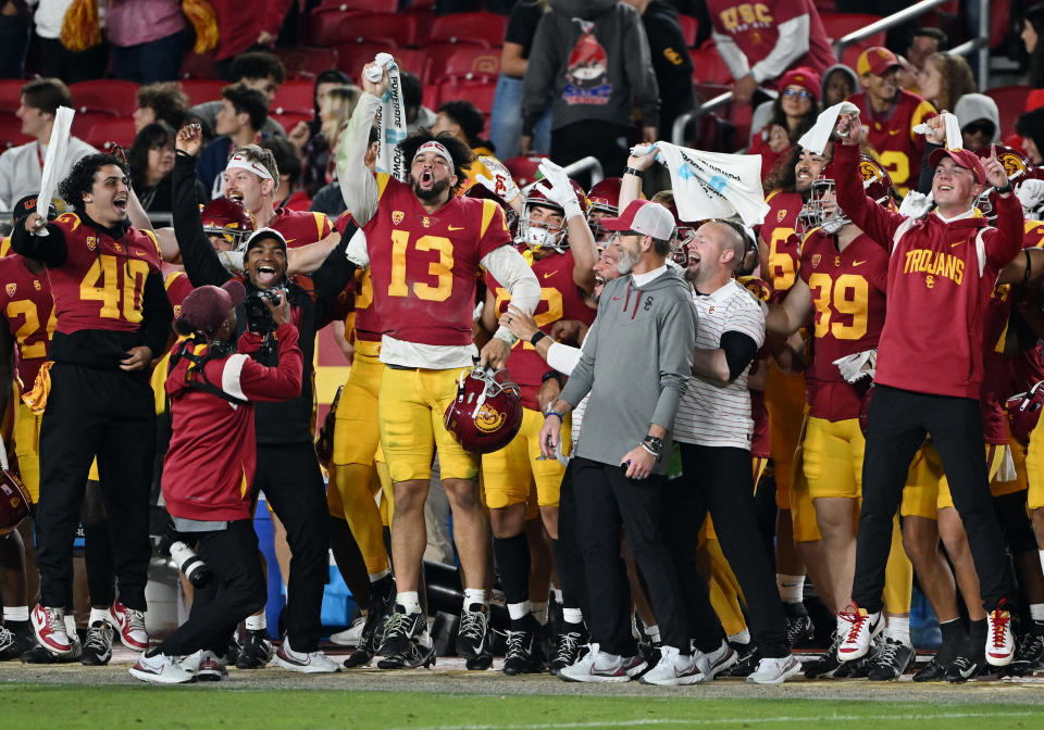 LOS ANGELES, CA - NOVEMBER 26: USC Trojans quarterback Caleb Williams (13) celebrating on the sidelines late in the fourth quarter of a college football game against the Notre Dame Fighting Irish played on November 26, 2022 at the Los Angeles Memorial Coliseum in Los Angeles, CA. (Photo by John Cordes/Icon Sportswire via Getty Images)