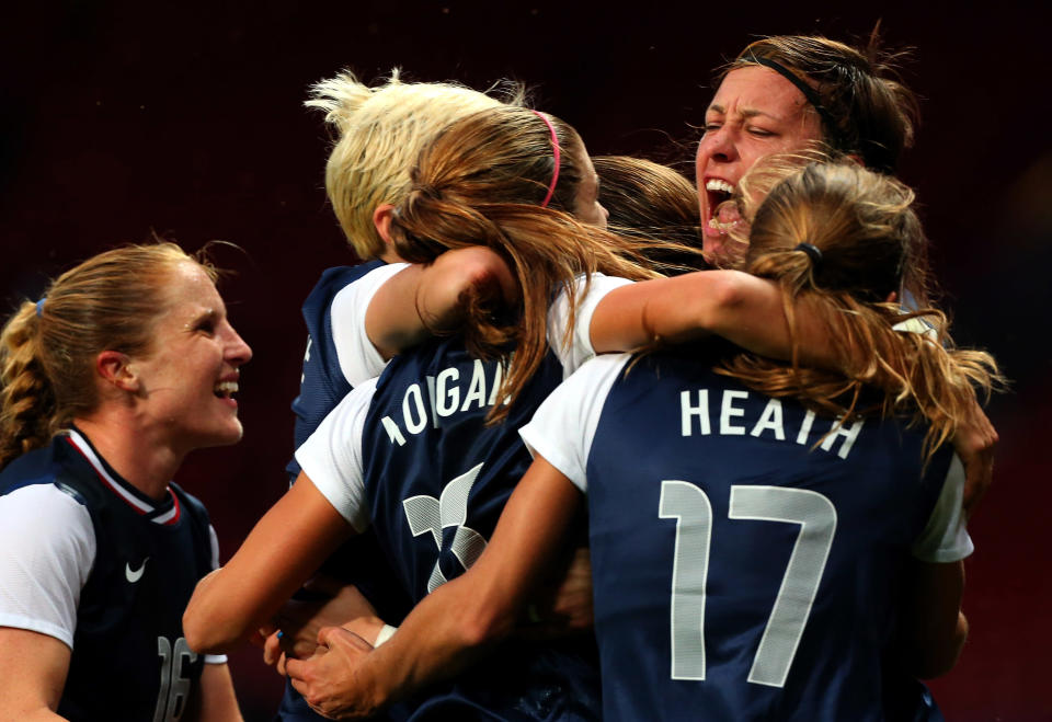 Alex Morgan #13 of the United States celebrates with her team-mates after scoring the winning goal in extra time during the Women's Football Semi Final match between Canada and USA, on Day 10 of the London 2012 Olympic Games at Old Trafford on August 6, 2012 in Manchester, England. (Photo by Stanley Chou/Getty Images)<br><br> <b>Related video:</b> <a href="http://yhoo.it/NmtL7i" rel="nofollow noopener" target="_blank" data-ylk="slk:Hope Solo saves the day again for U.S.;elm:context_link;itc:0;sec:content-canvas" class="link ">Hope Solo saves the day again for U.S.</a>