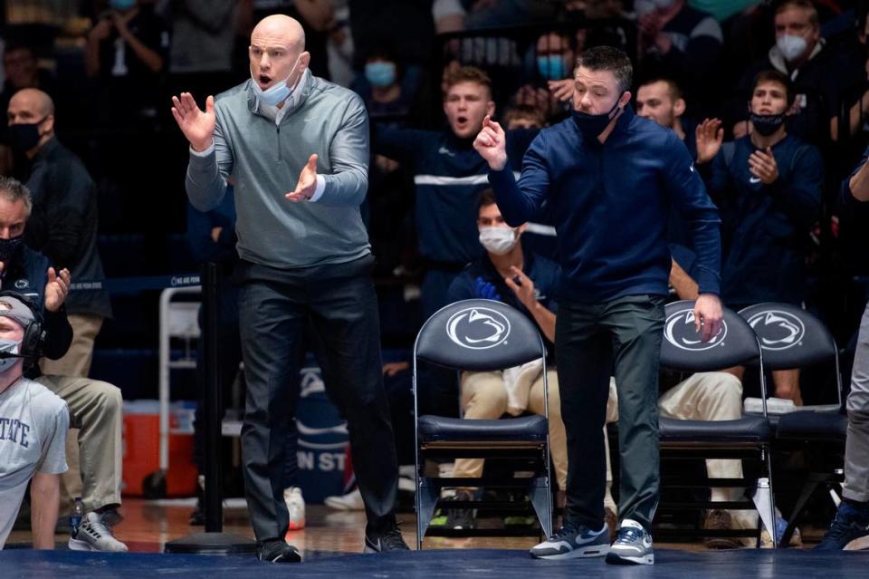 Penn State head coach Cael Sanderson and Penn State assistant coach Cody Sanderson yell during a wrestling dual between Penn State and Rutgers on Sunday, Jan. 16, 2022 at Rec Hall in University Park, Pa. Penn State defeated the Scarlet Knights 27-11.