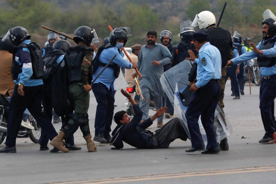 Police clash with supporters of Imran Khan outside the judicial complex in Islamabad where he was due to appear on 18 March (REUTERS)