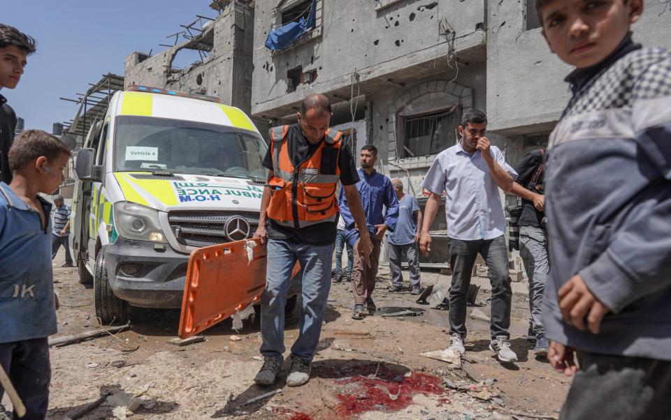 A Palestinian medic arrives at the site of an Israeli strike on al-Bureij camp