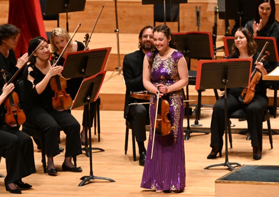 Alina Baron smiles at the audience after playing the violin at the Salute to Youth concert at Abravanel Hall in Salt Lake City on Wednesday, Nov. 22, 2023. | Scott G Winterton, Deseret News