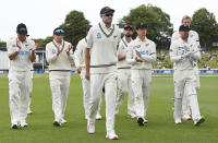 New Zealand players leave the field led by Tim Southee, center, after dismissing the West Indies for 138 runs during play on day three of their first cricket test in Hamilton, New Zealand, Saturday, Dec. 5, 2020. (Andrew Cornaga/Photosport via AP)
