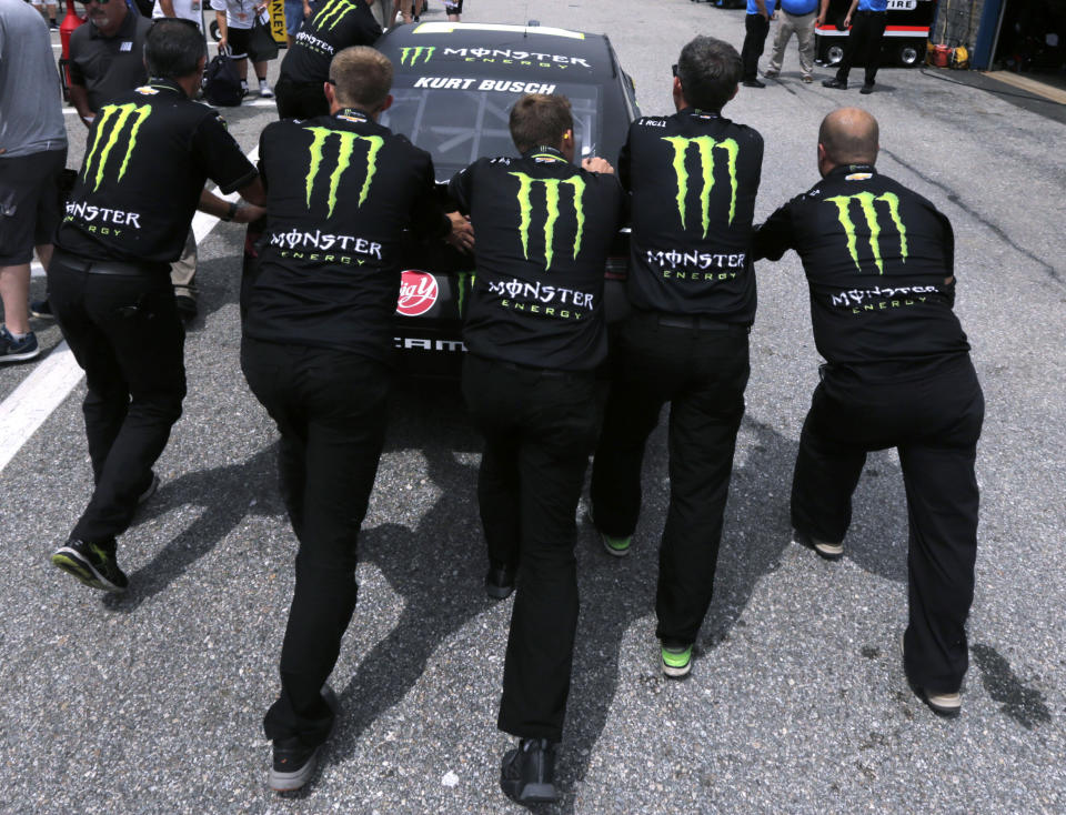 Kurt Busch's team pushes his car towards inspection prior to a NASCAR Cup Series auto race practice at New Hampshire Motor Speedway in Loudon, N.H., Saturday, July 20, 2019. (AP Photo/Charles Krupa)