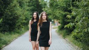 Two-Young-Women-In-Little-Black-Dresses-Stock-Photo