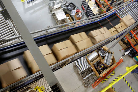 Boxes of toys move on a conveyor belt in the Toys 'R' Us vendor Learning Resources warehouse in Vernon Hills, Illinois, U.S., March 16, 2018. REUTERS/Joshua Lott