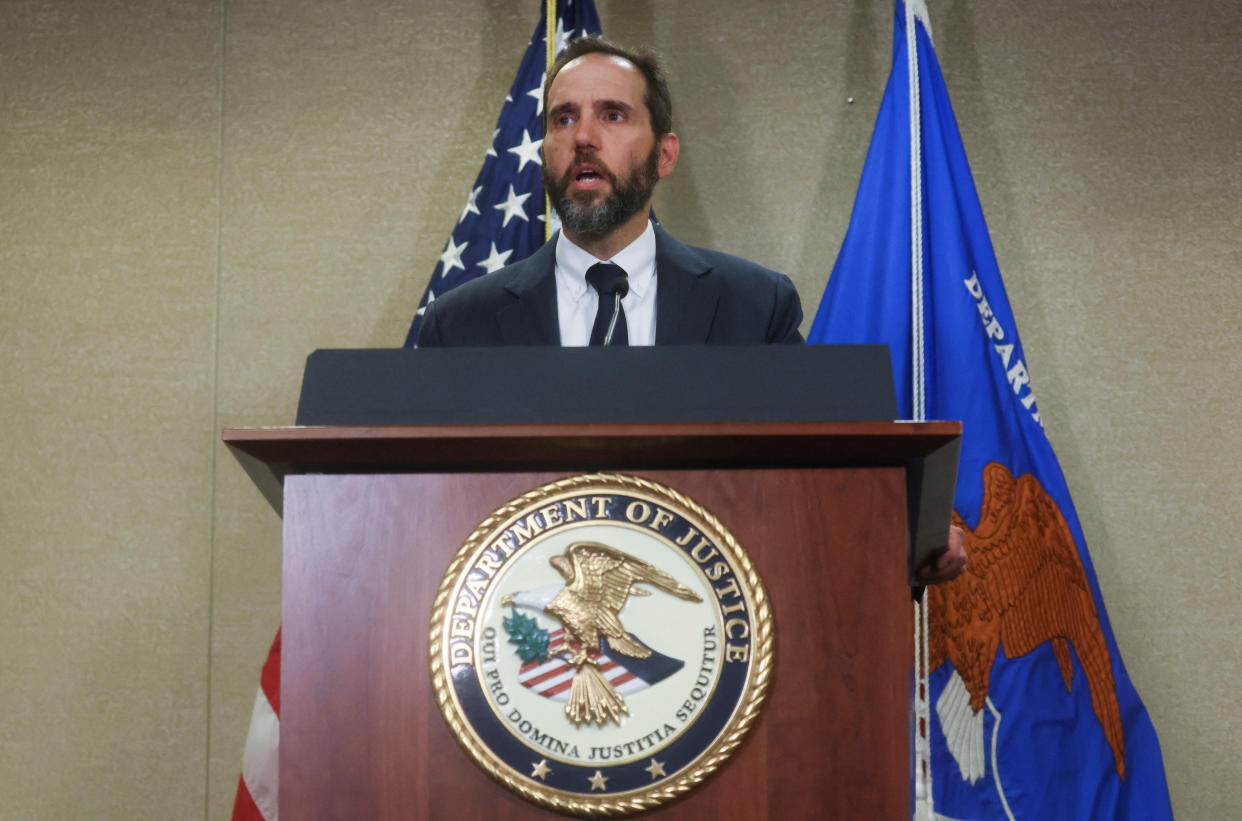 Special counsel Jack Smith at the microphone at a podium bearing the seal of the Department of Justice.