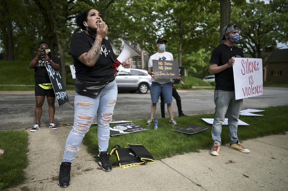 Ashley Quinones, widow of Brian Quinones, who was killed by Edina and Richfield police in 2019, protest outside Hennepin County Attorney Mike Freeman's home in Minneapolis, Minn. Wednesday, May 27, 2020. Mayor Jacob Frey on Wednesday called for an arrest and charges against the now-fired Minneapolis police officer Derek Chauvin who knelt on the neck of George Floyd as he pleaded to breathe shortly before his death, in an incident caught on video that drew international outrage. Frey said he is calling upon Freeman to seek charges involved with the Monday incident. (Aaron Lavinsky/Star Tribune via AP)