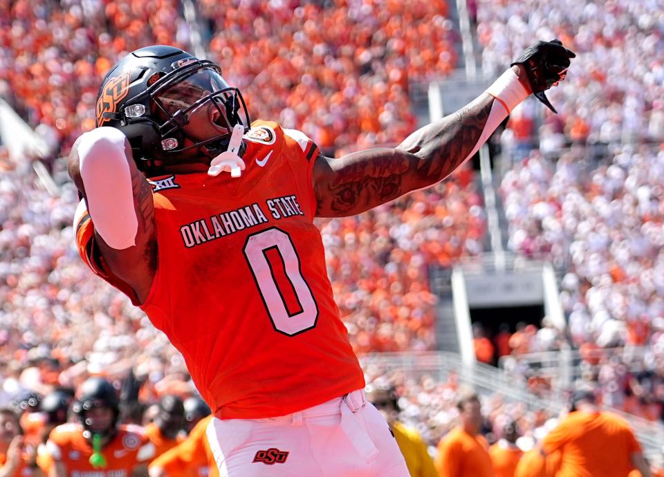 Oklahoma State's Ollie Gordon II (0) celebrates in the second half of the college football game between the Oklahoma State Cowboys and the Arkansas Razorbacks at Boone Pickens Stadium in Stillwater, Okla.,, Saturday, Sept., 7, 2024.