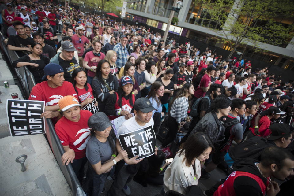 Toronto Raptors fans gather to watch television coverage of Game 4 of basketball’s NBA Finals between the Raptors and the Golden State Warriors, outside the arena where the Raptors play their home games, Friday, June 7, 2019, in Toronto. (Tijana Martin/The Canadian Press via AP)