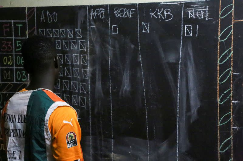 An election official counts the ballots during the presidential election in Abidjan