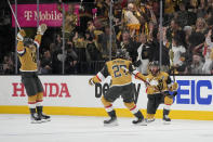 Vegas Golden Knights right wing Jonathan Marchessault, right, celebrates his goal against the Florida Panthers with Vegas Golden Knights defenseman Shea Theodore (27) during the first period of Game 2 of the NHL hockey Stanley Cup Finals, Monday, June 5, 2023, in Las Vegas. (AP Photo/John Locher)