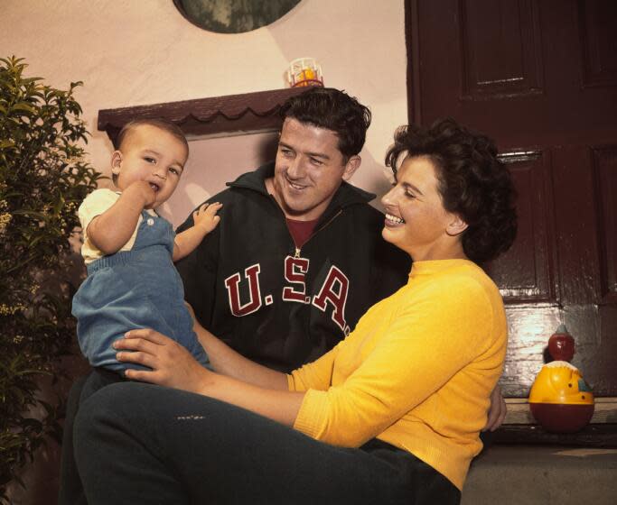 Olympic champions Harold Connolly and Olga Fikotova with their son. The pair met.
