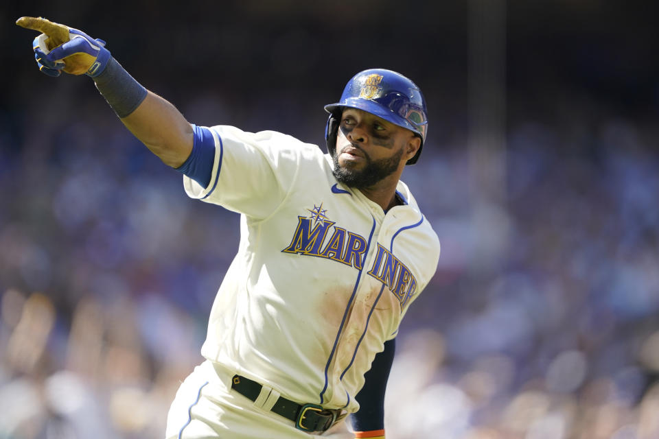 Seattle Mariners' Carlos Santana gestures as he heads to first after hitting a two-run home run against the Toronto Blue Jays during the eighth inning of a baseball game, Sunday, July 10, 2022, in Seattle. Santana had two home runs and the Mariners won 6-5. (AP Photo/Ted S. Warren)