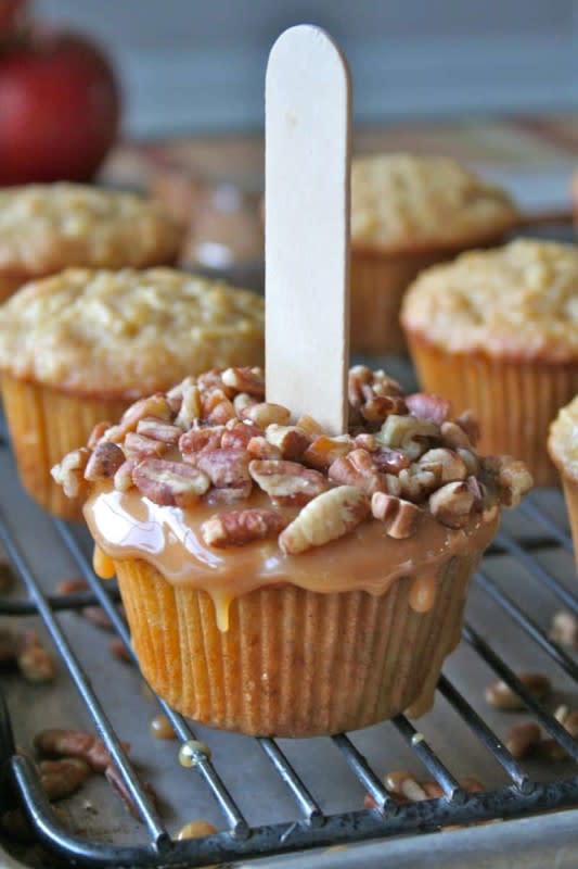 <p>The Baker Mama</p><p> Spiced apple cupcakes covered with gooey caramel and crunchy nuts for fun and tasty caramel apple cupcakes.</p><p><strong>Get the recipe:</strong> <a href="https://thebakermama.com/recipes/caramel-apple-cupcakes/" rel="nofollow noopener" target="_blank" data-ylk="slk:Caramel Apple Cupcakes;elm:context_link;itc:0;sec:content-canvas" class="link rapid-noclick-resp"><strong>Caramel Apple Cupcakes</strong></a></p>