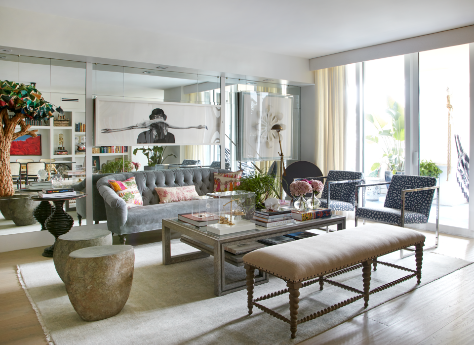 For their author and art collector clients, James and Miriam Duncan designed an airy, pale blue Miami kitchen filled with books and art while also taking advantage of the tropical garden surrounding it.