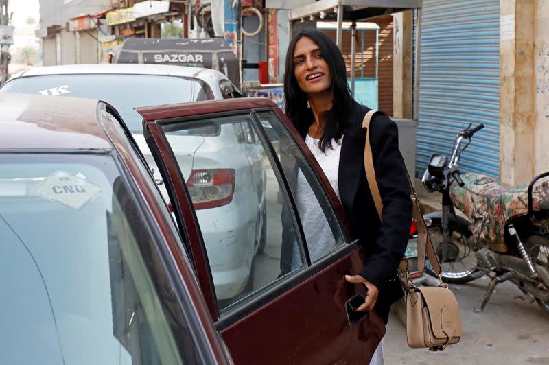 Nisha Rao, 28, a transgender woman who became country's first practicing lawyer, boards a cab, in Karachi,