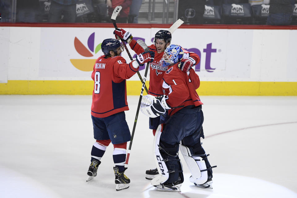 Washington Capitals goaltender Pheonix Copley (1) celebrates with right wing Tom Wilson, center, and left wing Alex Ovechkin (8), of Russia, after an NHL hockey game against the Buffalo Sabres, Saturday, Dec. 15, 2018, in Washington. (AP Photo/Nick Wass)