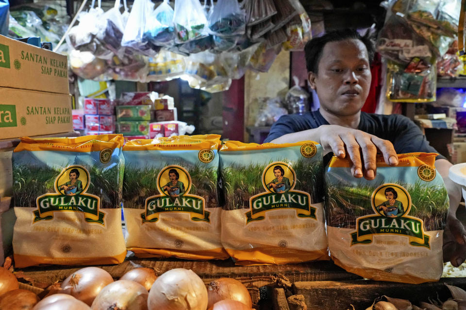 A vendor arrange packages of sugar at a market in Jakarta, Indonesia on Tuesday, Oct. 24, 2023. Indonesia — the biggest sugar importer last year, according to the United States Department of Agriculture — has cut back on imports. (AP Photo/Tatan Syuflana)