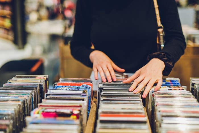 A person rummaging through DVDs