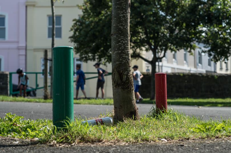 A Stella can left on the floor near to where kids are playing