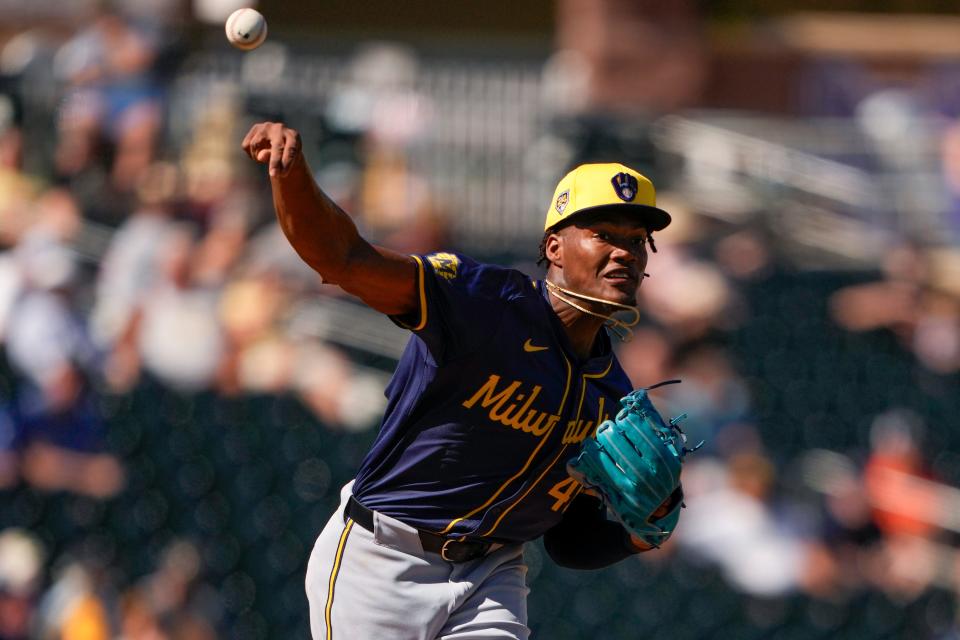 Milwaukee Brewers relief pitcher Abner Uribe throws to first base in a pickoff attempt against the Texas Rangers during the fourth inning of a spring training baseball game Thursday, Feb. 29, 2024, in Surprise, Ariz. (AP Photo/Lindsey Wasson)