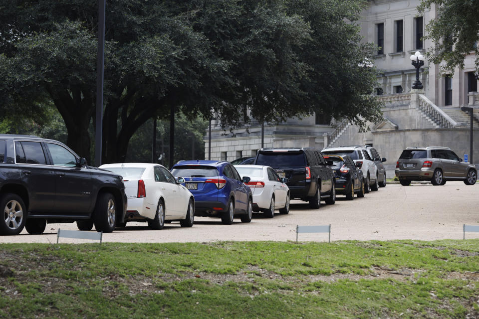 Mississippi legislators, staff and Capitol employees take advantage of a drive-thru COVID-19 testing center on the Capitol grounds in Jackson, Miss., Monday, July 6, 2020, following an incidence at the Mississippi Legislature. House Speaker Philip Gunn confirmed Sunday that he had recently tested positive for COVID-19. (AP Photo/Rogelio V. Solis)