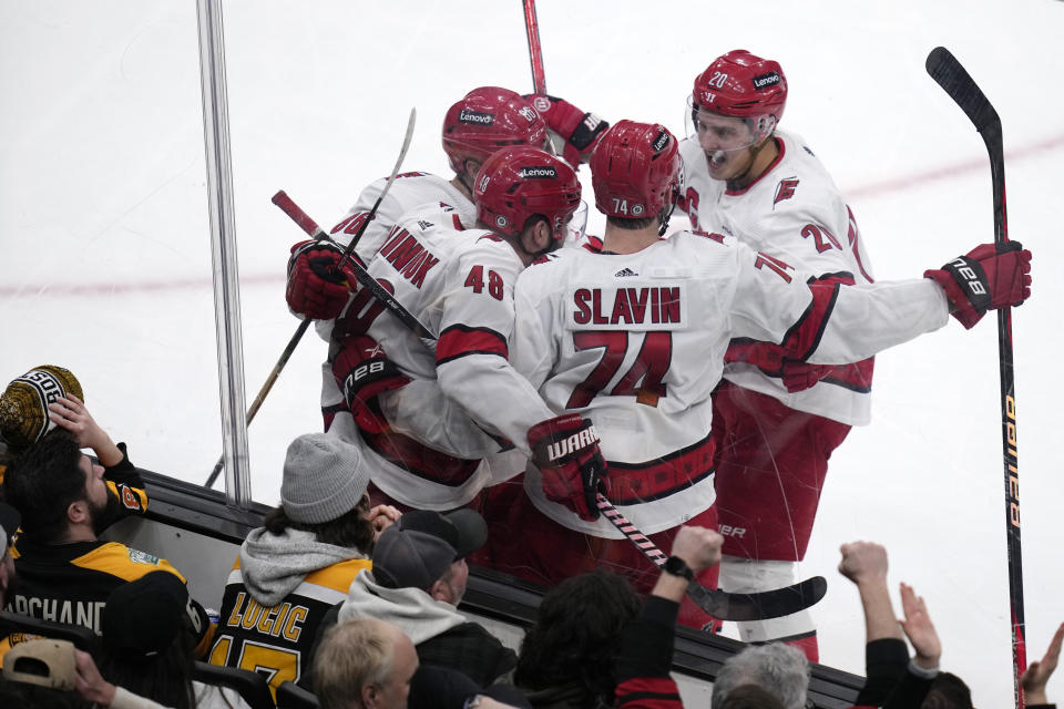 Carolina Hurricanes left wing Jordan Martinook (48) is congratulated by teammates after his goal against the Boston Bruins, breaking a 2-2 tie, during the third period of an NHL hockey game Wednesday, Jan. 24, 2024, in Boston. (AP Photo/Charles Krupa)