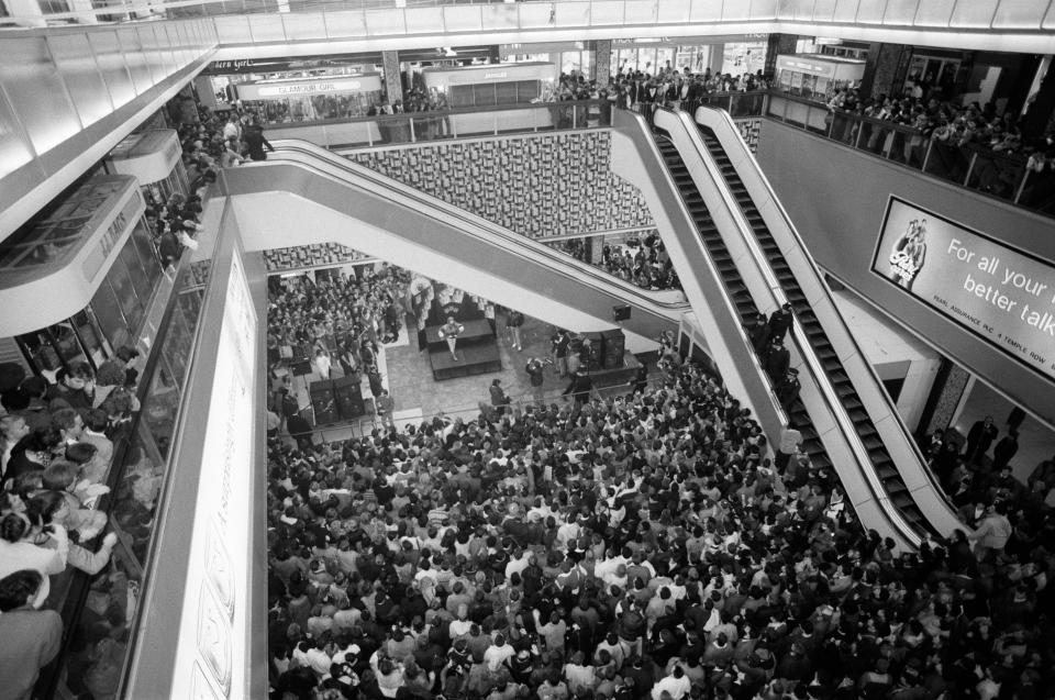 Thousands of young pop fans gather at the Bull Ring Shopping Centre for pop singer Tiffany (pictured center, on a small stage), in Birmingham, West Midlands on January 19, 1988.