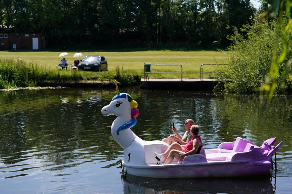 A couple travel along the river Avon on a pedal boat during warm weather in Warwick (Jacob King/PA) (PA Wire)