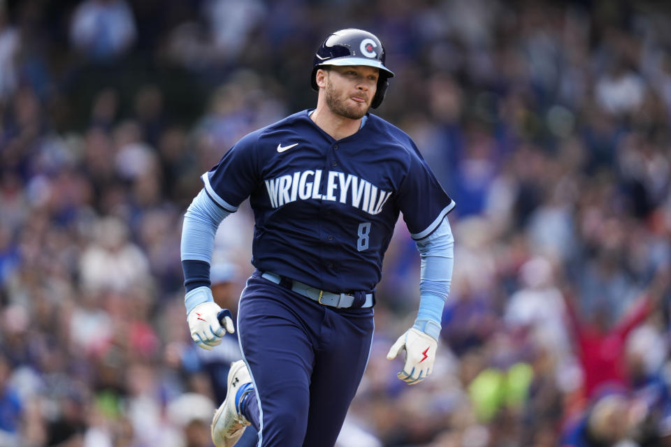 Chicago Cubs' Ian Happ runs to first base during the sixth inning of a baseball game against the Baltimore Orioles, Friday, June 16, 2023, in Chicago. (AP Photo/Erin Hooley)