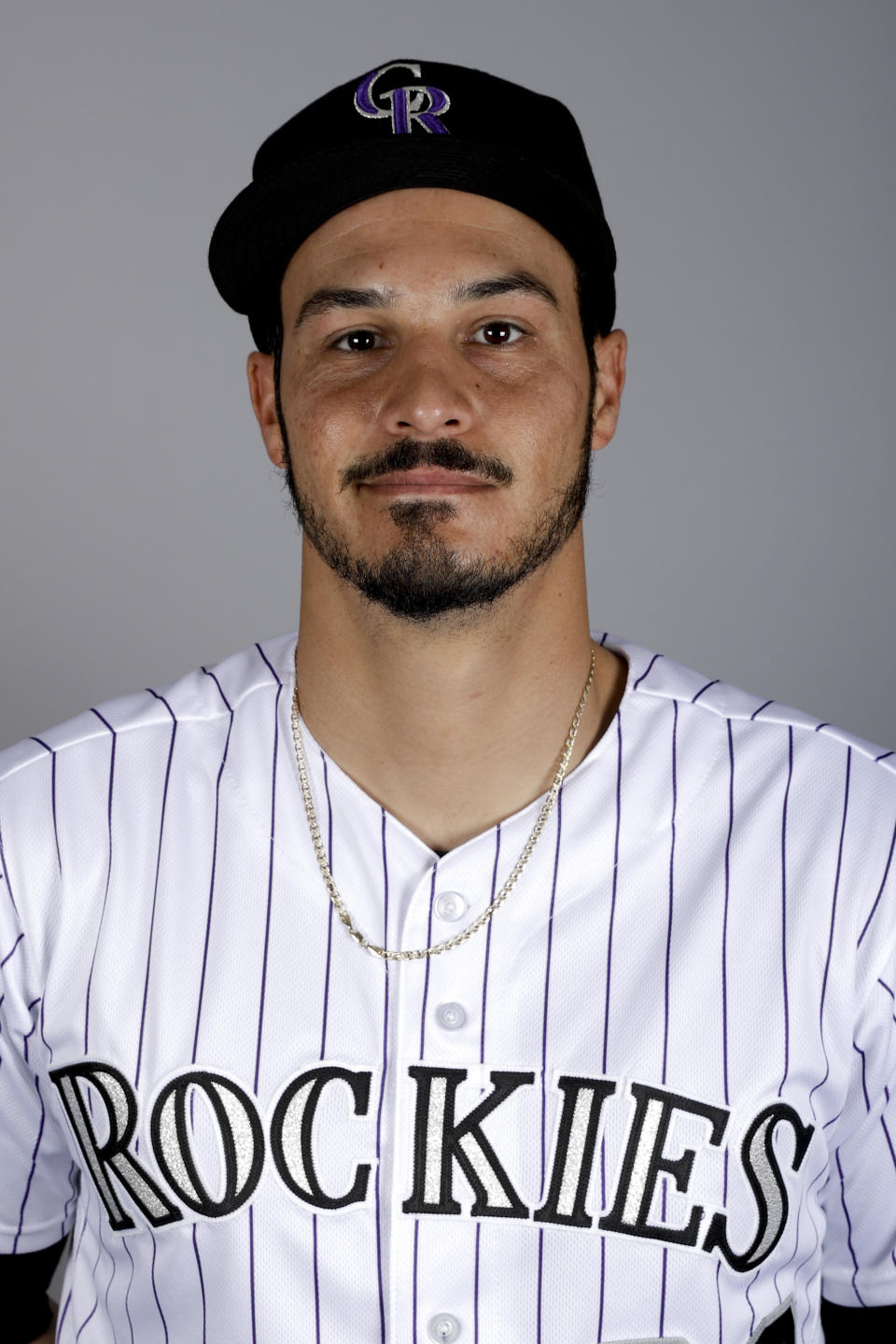 File-This is a 2019 photo of Nolan Arenado of the Colorado Rockies. Arenado likes where he's at and the direction the Colorado Rockies are headed. So he's staying put. For possibly a long, long time. And for a chance to finish what this team has been brewing. The All-Star third baseman agreed to a $260 million, eight-year contract on Tuesday, Feb. 26, 2019, a person familiar with the negotiations told The Associated Press. The person spoke on condition of anonymity because the deal has not been finalized. (AP Photo/Chris Carlson, File)