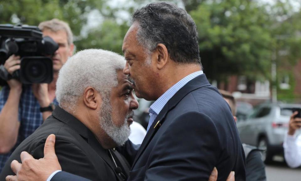 The Rev Jesse Jackson and the Rev Robert Smith Jr speak outside New Bethel Baptist church on 16 August.