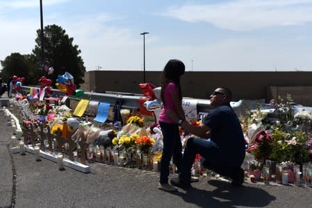 People pay their respects two days after a mass shooting in El Paso