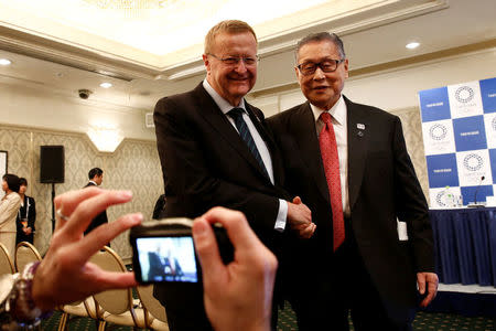 International Olympic Committee (IOC) Vice President and Chairman of the Coordination Commission for the Tokyo 2020 Games John Coates (L) and Yoshiro Mori, head of the 2020 Tokyo Olympics organising committee shake hands as they pose to journalists after their news conference in Tokyo, Japan, December 2, 2016. REUTERS/Kim Kyung-Hoon