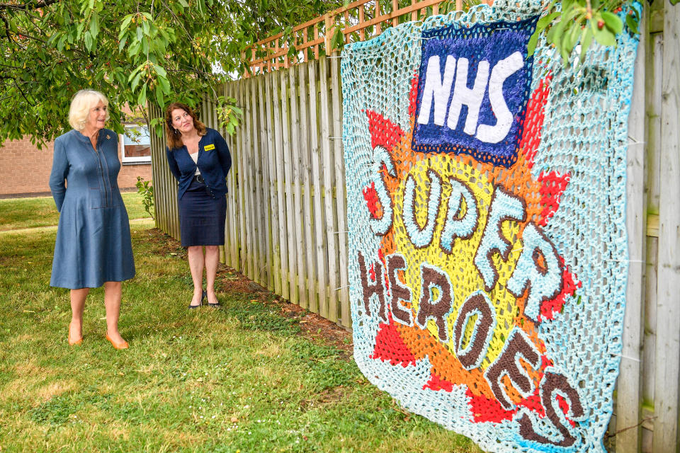The Duchess of Cornwall is shown a knitted tribute to NHS staff by Chief Executive Officer, Gloucestershire Hospitals NHS Foundation, Deborah Lee, as she meets front line key workers who who have responded to the COVID-19 pandemic during a visit to Gloucestershire Royal Hospital.