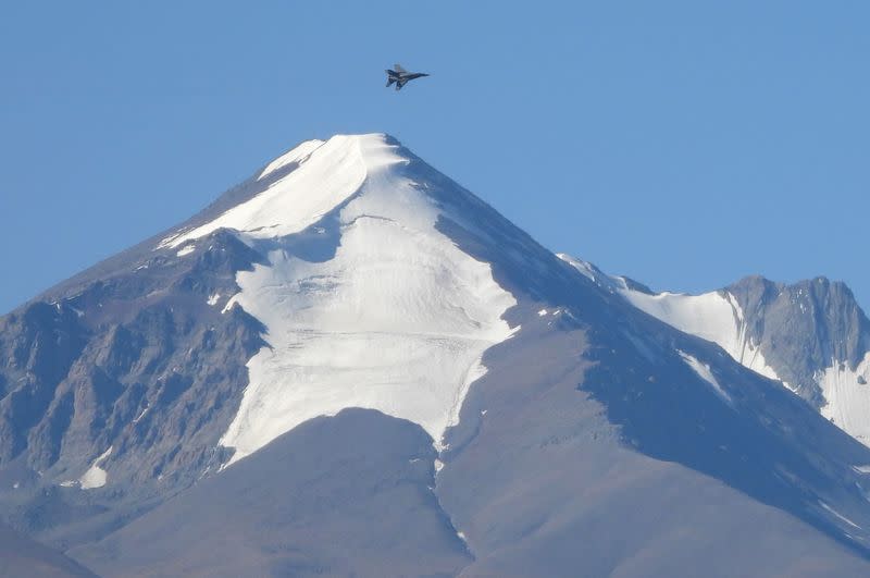 An Indian fighter plane flies over a mountain range in Leh