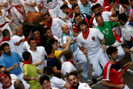 Sergio Colas reacts amid runners during a crowded bull run at San Fermin festival in Pamplona, northern Spain, July 8, 2016. REUTERS/Susana Vera