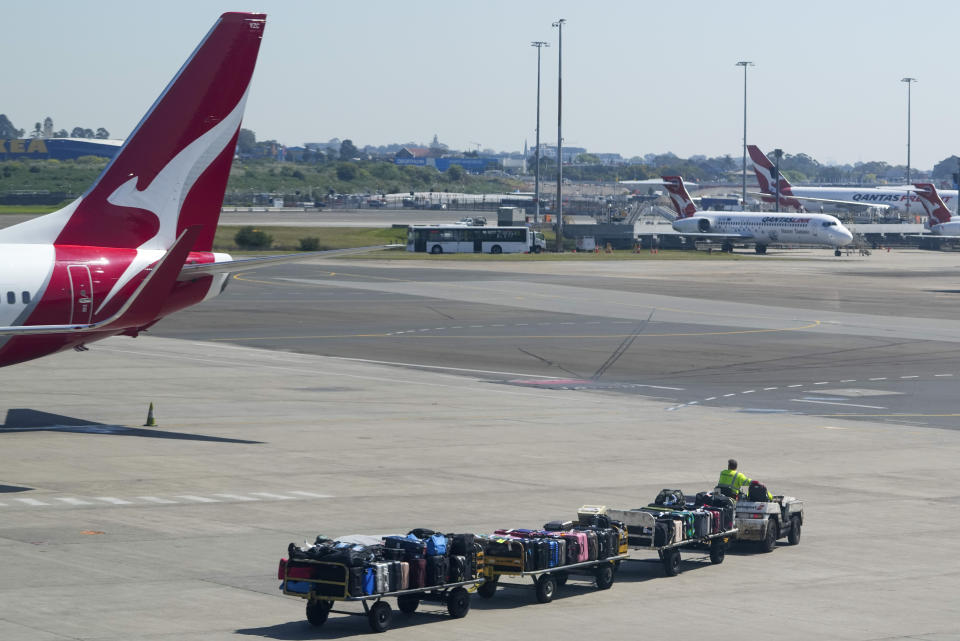 A baggage handler drives past a Qantas jet at Sydney's domestic terminal, Wednesday, Sept. 13, 2023. Qantas Airways lost its challenge to a court ruling on Wednesday that the Australian flag carrier had illegally fired 1,700 baggage handlers, cleaners and other ground staff at the height of pandemic travel disruptions. (AP Photo/Mark Baker)