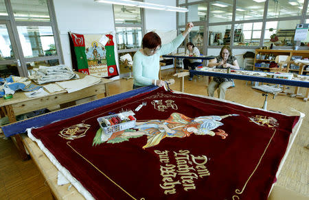 Seamstresses are pictured while working in the sewing of the Fahnen Koessinger company in Schierling, Germany April 10, 2018. Picture taken April 10, 2018. REUTERS/Michaela Rehle