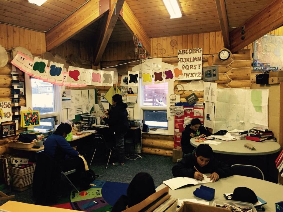 Students draw in the part of Colville Lake's one-room schoolhouse that holds cultural studies. Classes for the younger students are held next door in a one-room portable.