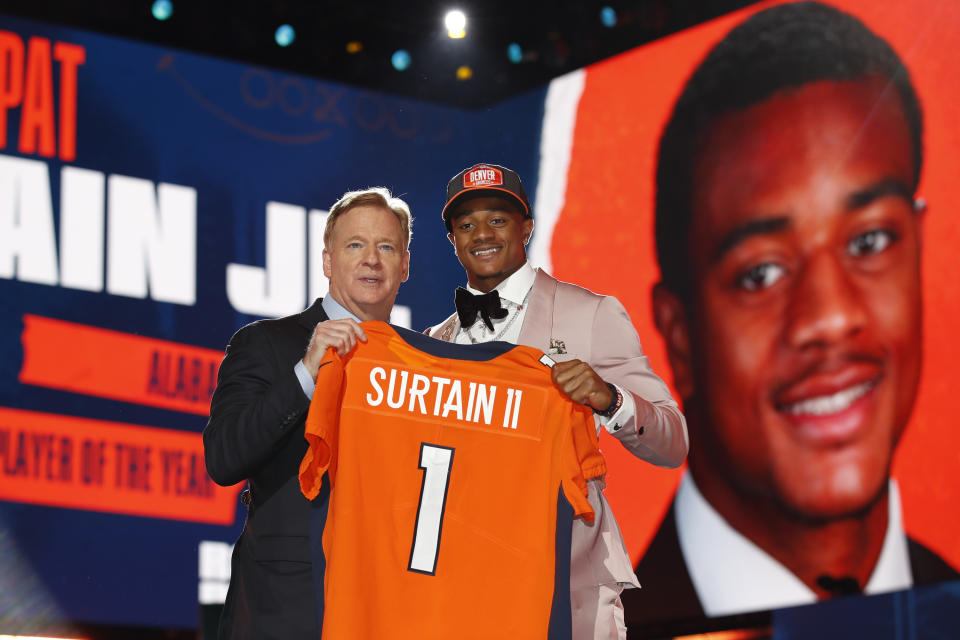 Cornerback Patrick Surtain II, right, holds a Broncos jersey with NFL commissioner Roger Goodell after he was drafted. (Jeff Haynes/AP Images for Panini)