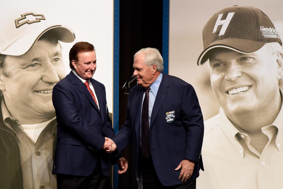 Hall of Fame inductees Richard Childress, left, and Rick Hendrick shake hands after receiving their Hall of Fame jackets.