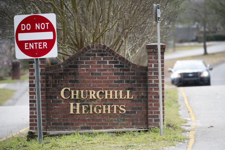 A police officer blocks a road near an entrance to the Churchill Heights neighborhood Thursday, Feb. 13, 2020, in Cayce, S.C., where 6-year-old Faye Marie Swetlik recently went missing just after getting off a school bus. Hundreds of officers in Cayce, along with state police and FBI agents, are working around the clock to try to find Swetlik, who was last seen Monday, Cayce Public Safety Officer Sgt. Evan Antley reiterated Thursday. (AP Photo/Sean Rayford)