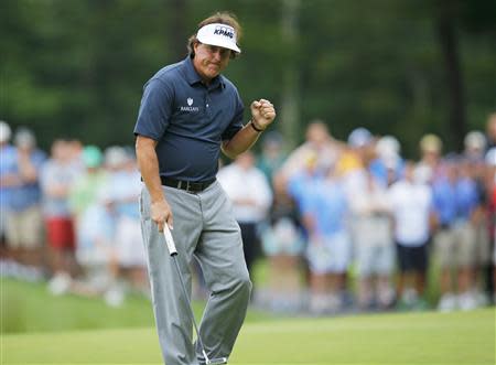 Phil Mickelson of the U.S. pumps his fist after a birdie on the 14th hole during the first round of the Deutsche Bank Championship in Norton