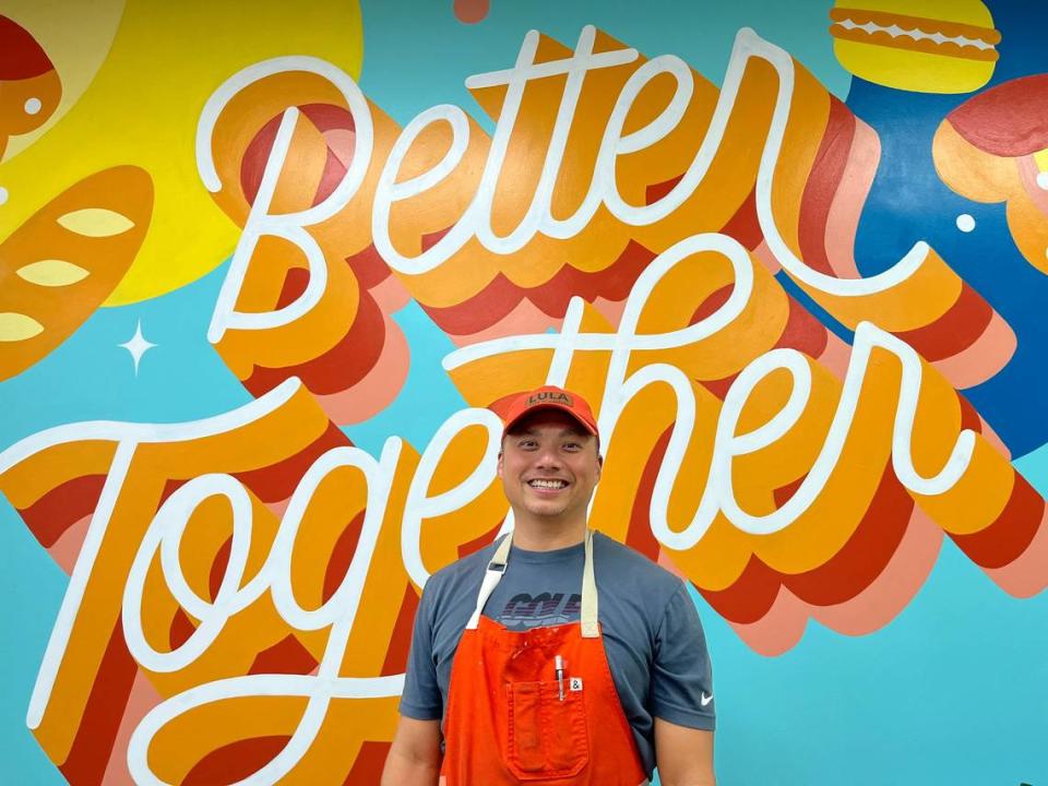 Lula Banh Mi & Bakery co-owner Vu Van. The shop’s “Better Together” mural was created by New York artist Steffi Lynn Tsai.