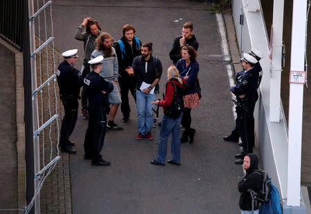 Anti-deportation protesters speak with police officers at Duesseldorf Airport, Germany September 12, 2017. REUTERS/Wolfgang Rattay